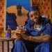 Davido raises a glass beside the Martell VS Afrobeats limited-edition bottle designed with Prince Gyasi