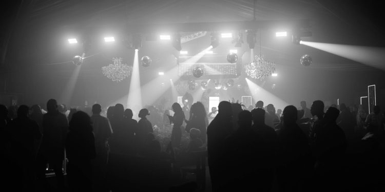 Guests under stage lights at an EMY Africa awards event in Accra