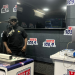 A guest in a black cap and T-shirt stands at the microphone in the Hitz FM studio as a presenter works the desk during the Multimedia Group and Influencer Africa takeover