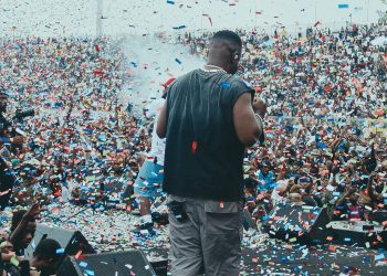 Sarkodie on stage facing a packed Baba Yara Sports Stadium crowd under falling confetti at Rapperholic Kumasi 26